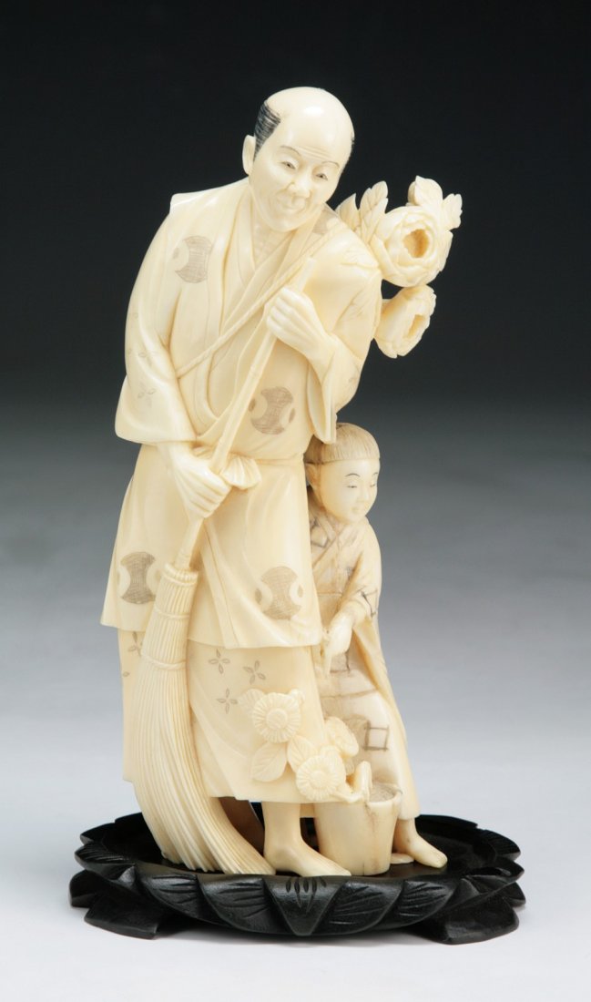 A Japanese Antique Ivory Group Okimono Figure: A Japanese Antique Ivory Group Okimono Figure: presented on a wood stand; Size: H: 6-1/2"; (overall) H: 7-1/4"