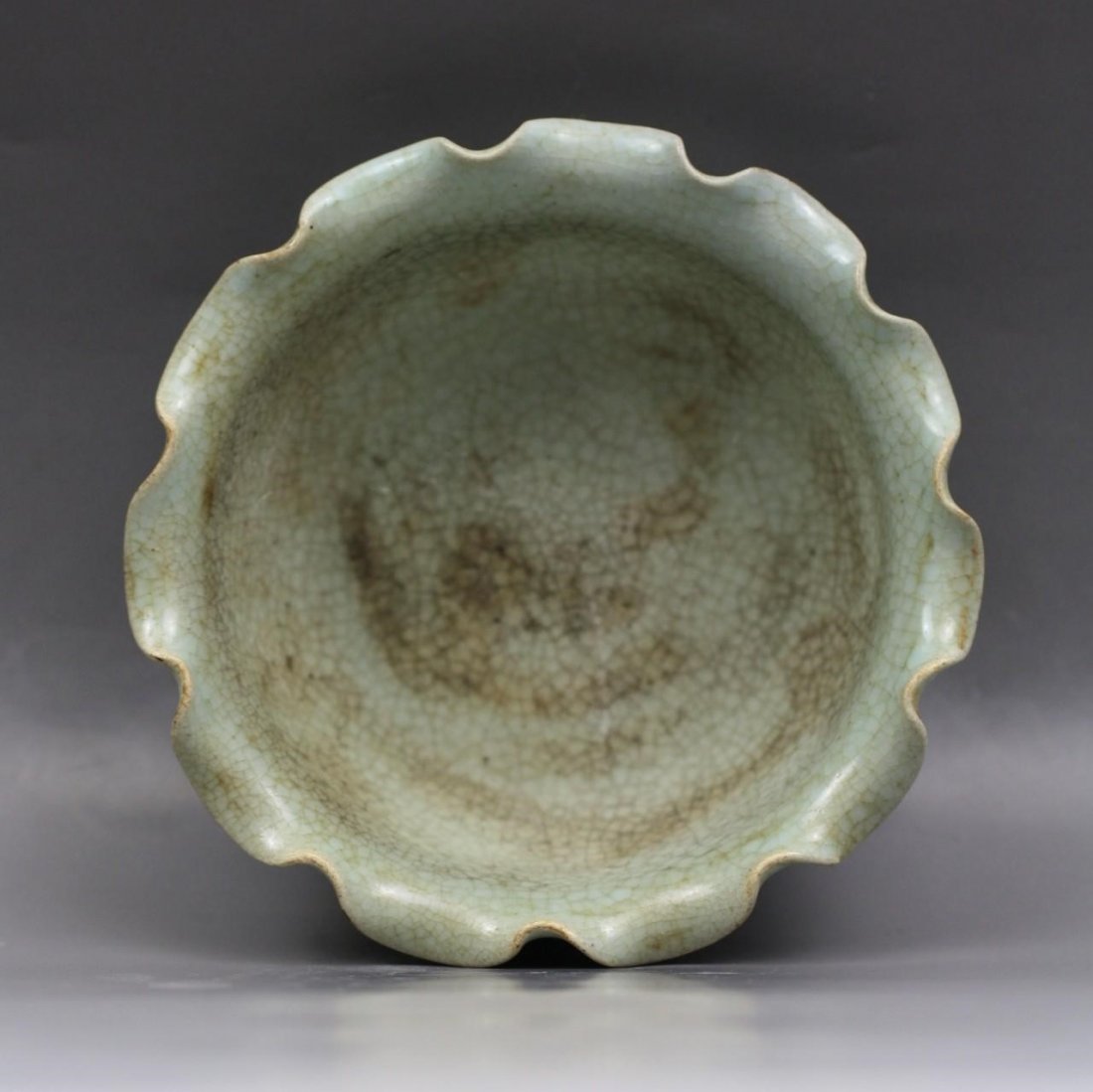 A Song Style Celadon Glazed Bowl: A Song Style Celadon Glazed Bowl: potted with heavily foliated rim, covered inside and outside with a thick grayish blue glaze with an attractive network of crackle, the base displaying three spur mar