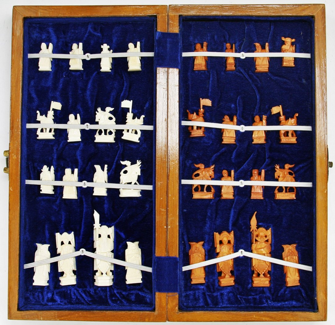 A Complete Set of Chinese Carved Ivory Chess: A Complete Set of Chinese Carved Ivory Chess: all pieces present, the opposing sides of white ivory and sienna dyed ivory are all solid carved pieces all raised on plinths, very good condition, in woo