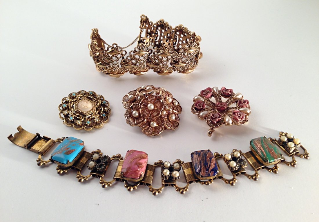 Group of vintage jewelry items: Measurements: bracelets: Diameter: 2 1/2". L: 7 1/2". Brooch: Diameter: 1 1/4". & 1 1/2". & 1 5/8".
