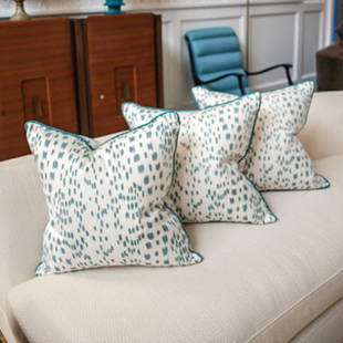 Three 20" square pillows of turqouise and white linen: Designer: Brian del Toro Three 20" square pillows of turqouise and white linen print