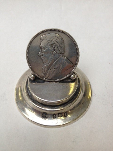A hallmarked silver card holder with a one shilling coi: A hallmarked silver card holder with a one shilling coin date 1897
