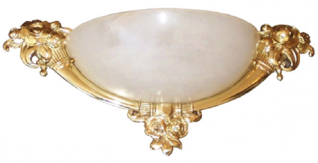 Pair French Art Deco Sconces In The Style Of Sue Et: This pair of stylish French art deco wall sconces is in the style of Sue et Mare and dates to the 1920’s. The gold hued bronze surround is in the form of twin cornucopias with flower heads connected