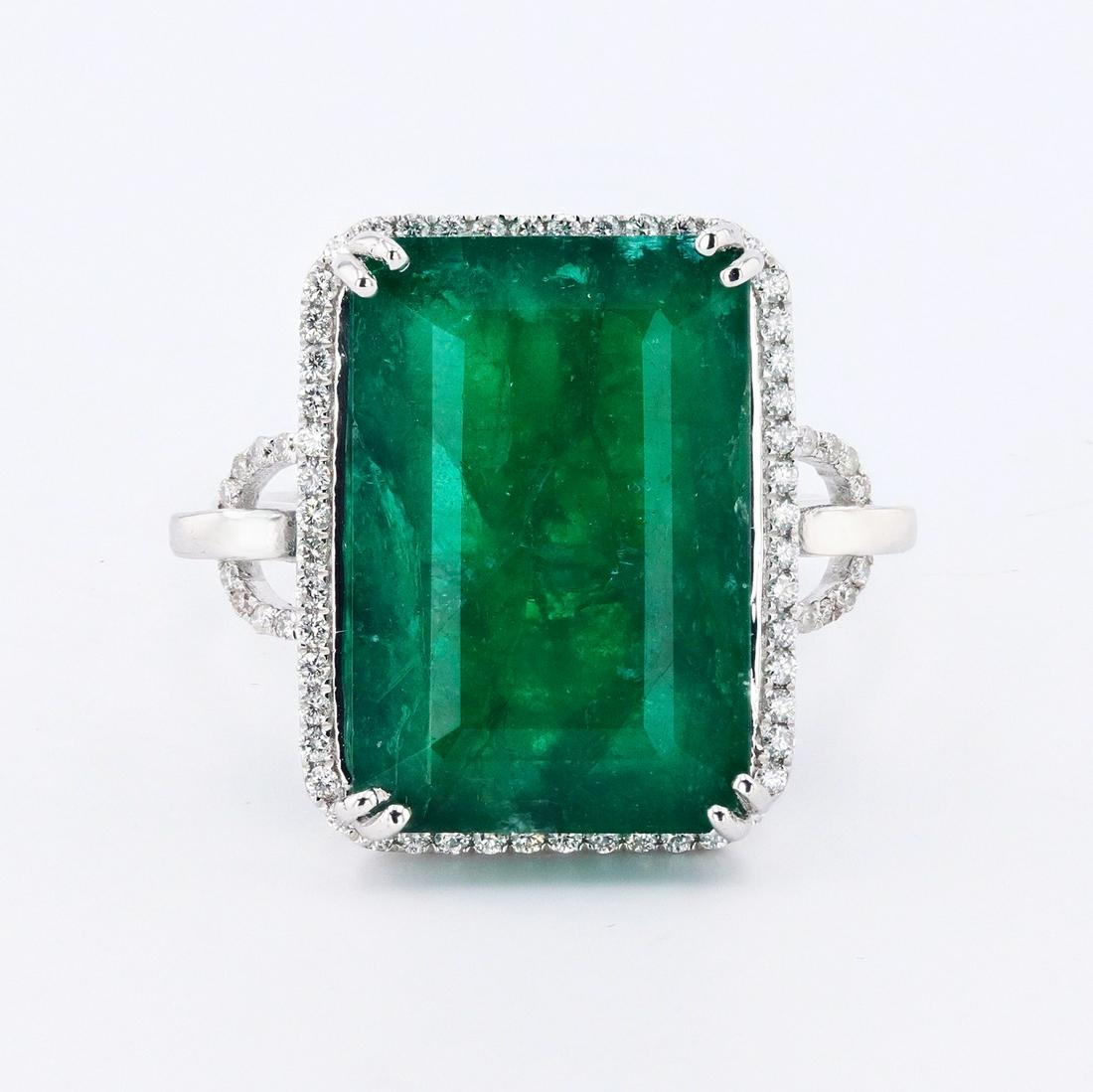 12.89ct Emerald and 0.27ctw Diamond 18K White Gold Ring: This stunning ring features an emerald cut 12.89ct green emerald and 68 round brilliant cut diamonds. This ring is set in 18K white gold, and is the perfect symbol of your commitment to love. The emer