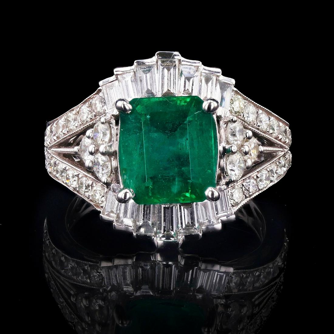 2.78ct Emerald and 1.54ctw Diamond 18K White Gold Ring: This ring features an emerald cut diamond center stone weighing 2.78ct and is surrounded by 48 diamond side stones weighing 1.54ctw. The ring is size 6 1/2. and is made of 18K white gold.