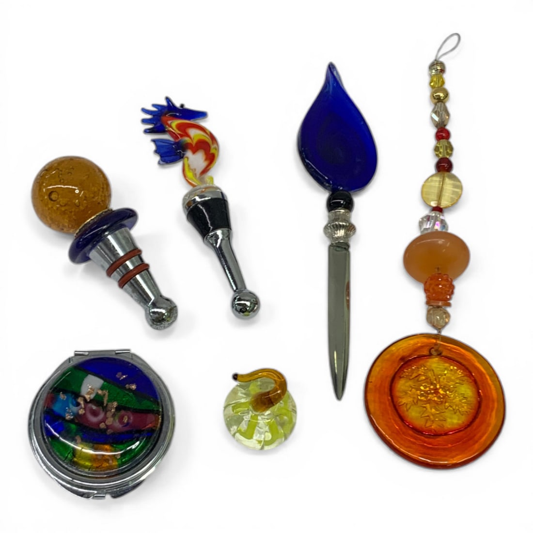 Group Of Misc. Art Glass: 2 Art Glass Stoppers, 7" Art Glass Letter Opener, Enameled & Chrome Compact, Glass Beads, Misc. Art Glass. See Photos.