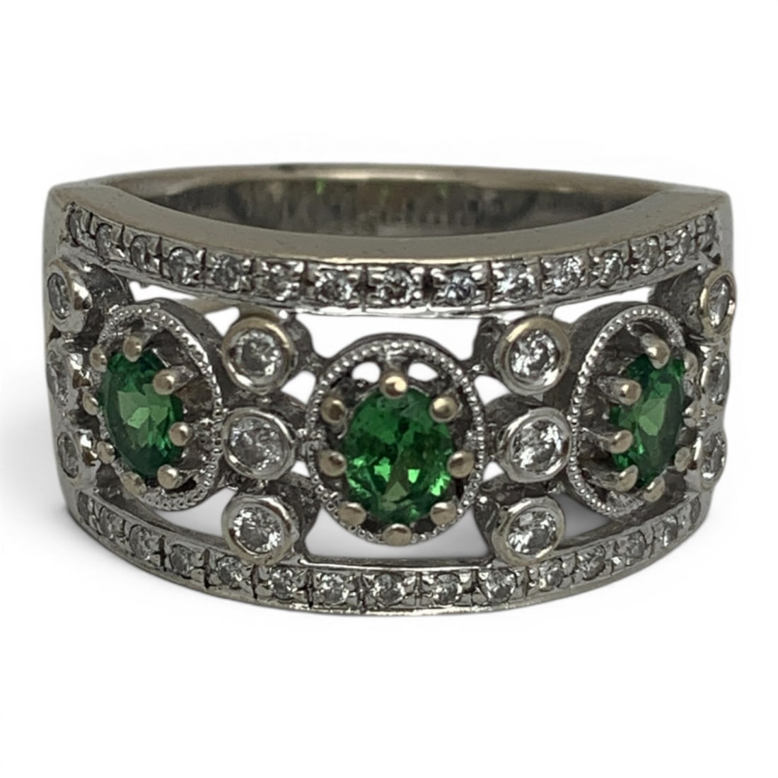 18k White Gold Diamond & Green Citrine Ring: 18k White Gold Ring With An Open Work Design Featuring 3 Oval Cut Green Citrine Gemstones Flanked By 12 Round Cut Diamonds Approx. 0.03ct Each And 30 Round Cut Diamonds Approx. 0.01ct Each. 42 Total D
