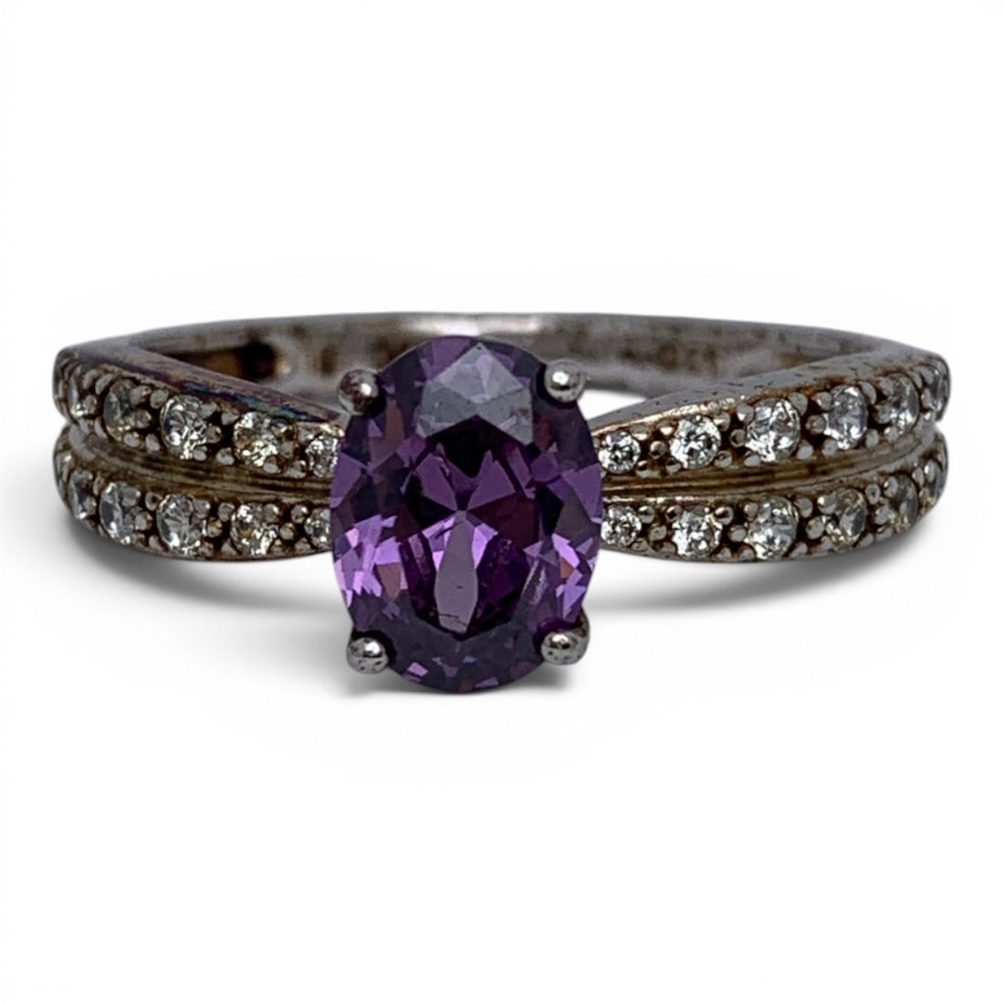 Sterling Silver Ring With Purple & Clear Stones: Sterling Silver Ring Featuring An Oval Cut Purple Stone & Clear Stones Set Along The Band Marked: 925 - Size 8 - 2.9 Grams