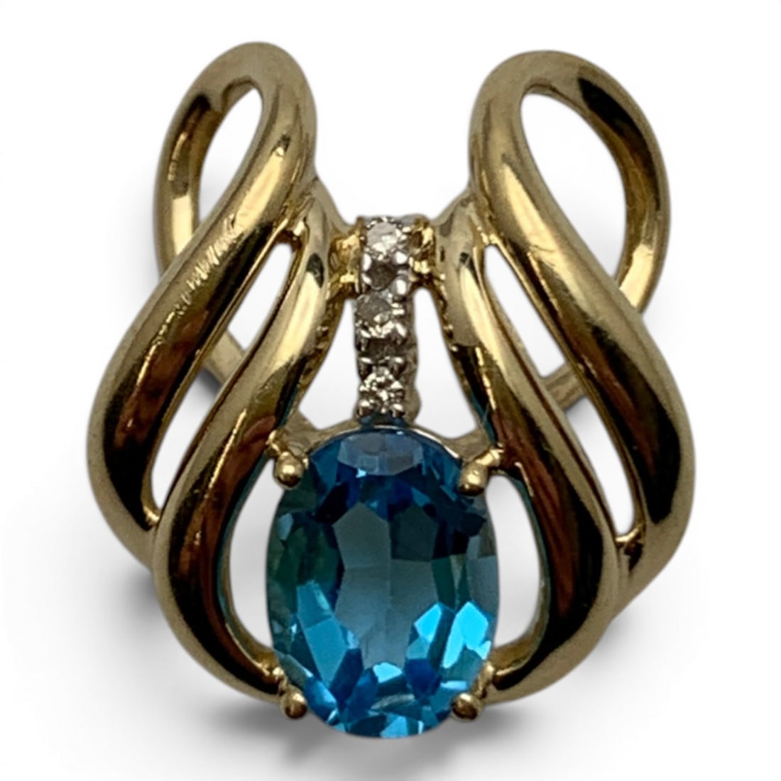 14k Yellow Gold Diamond & Blue Topaz Pendant: 14k Yellow Gold Pendant Featuring 1 Center Set Oval Cut Blue Topaz Gemstone And 3 Round Cut Earth Mined DiamondsMarked 14k - 3/4" Long - 1.6 DwtGemstones Tested With Presidium Gem Tester Il - Berners 
