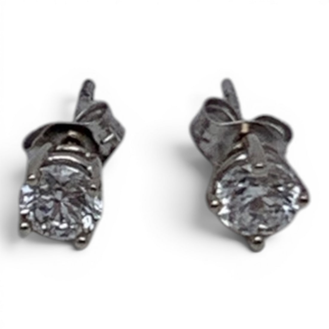Pair Of 14k White Gold & Diamond Earrings: Pair Of 14k White Gold Earrings Featuring A Round Cut Diamond Approx. 0.73ct Each.Marked: 14k - 1/8" Long Diameter - 0.5 DwtGemstones Tested With Presidium Gem Tester Il - Berners Does Not Guarantee