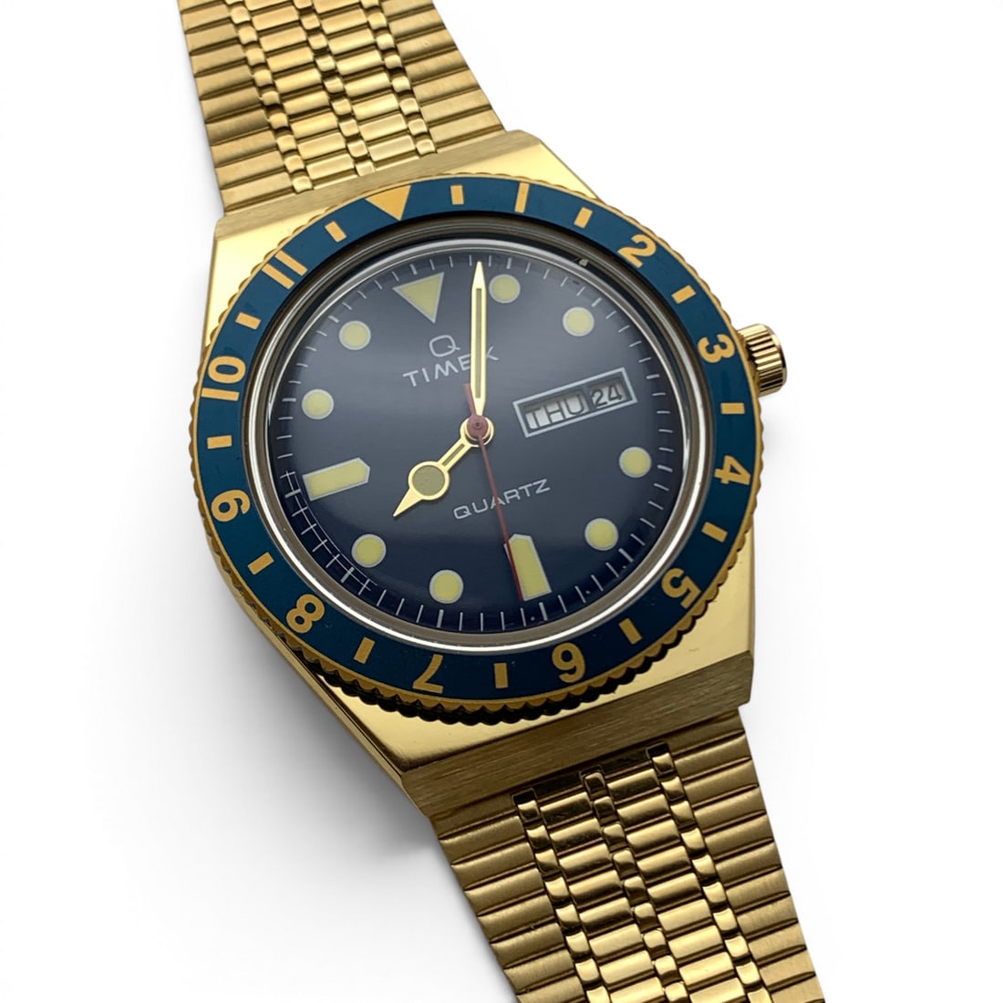 Vintage Q Timex Gold Tone Wrist Watch: Vintage Q Timex Gold Tone Wrist Watch Marked On Face: Q Timex, QuartzMarked On Back: Timex, All Stainless SteelMarked On Band: Stainless Steel9 1/2" Long - 1 1/2" Face Diameter Includes Original Box