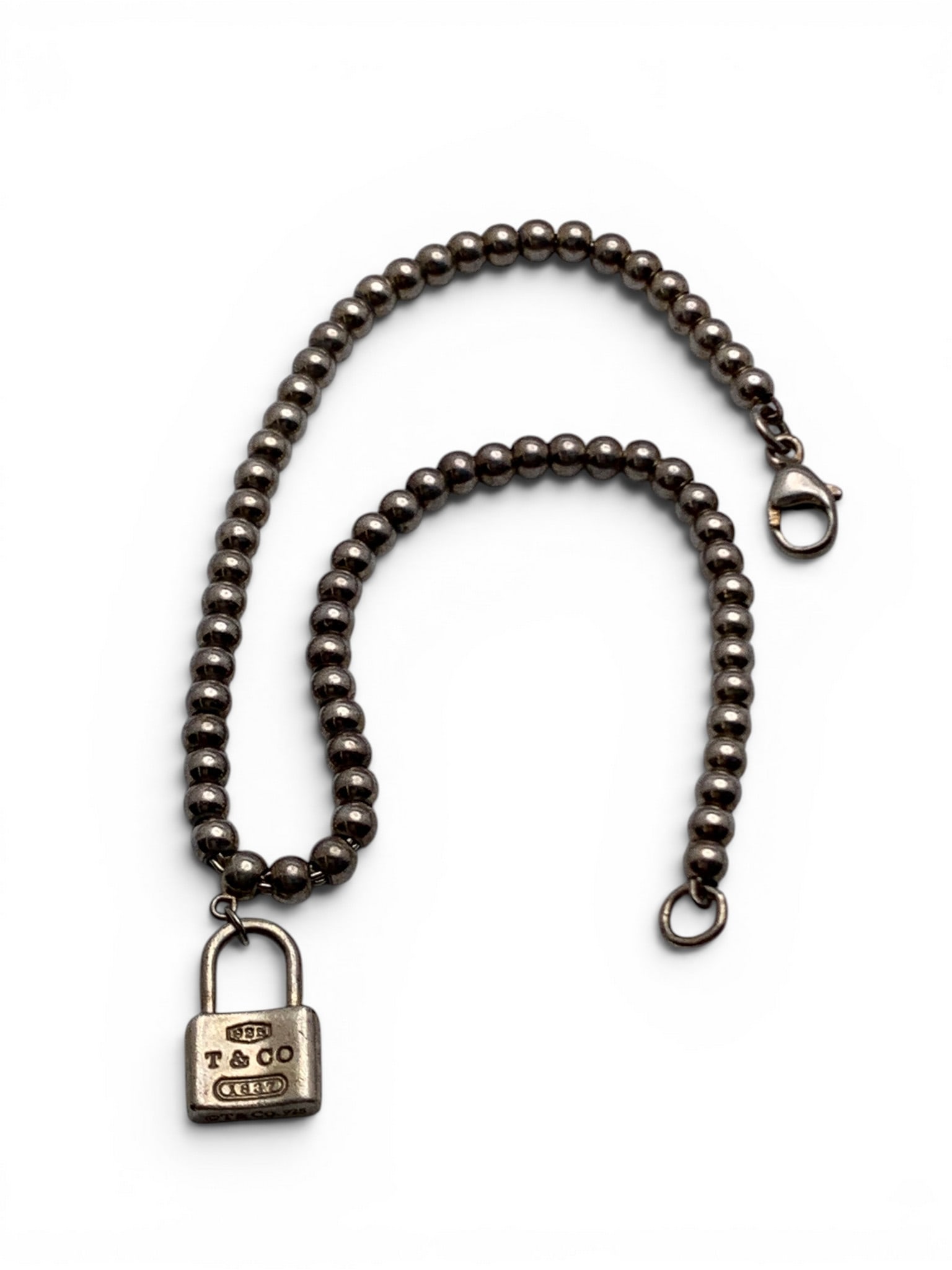Tiffany & Co Sterling Silver Beaded Bracelet: Tiffany & Co Sterling Silver Beaded Bracelet Featuring Small Lock CharmMarked: T & Co, 925, 1837 - 7 1/4" Long - 4.9 Grams