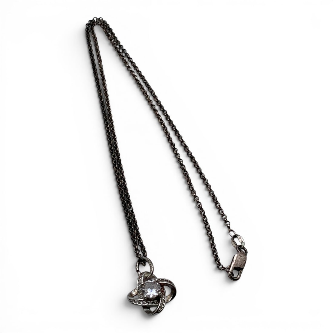 Sterling Silver & Clear Stone Pendant Necklace: Sterling Silver Necklace Featuring A Criss Cross Pendant With Clear Stones Marked 925 - 18 1/4" Long - 5.2 Grams