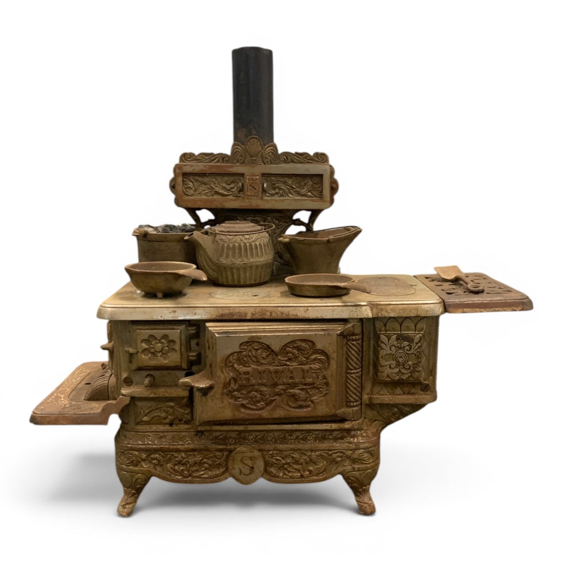 Antique J. & E. Stevens Rival Cast Iron Toy Stove: Antique J. & E. Stevens Rival Cast Iron Toy Stove Featuring Intricate Scrolling Details Cast Into The Iron And Includes 1 Kettle, 1 Frying Pan & 3 Pots18 1/2" Long, 17 1/4" Tall, 6 1/2" Deep