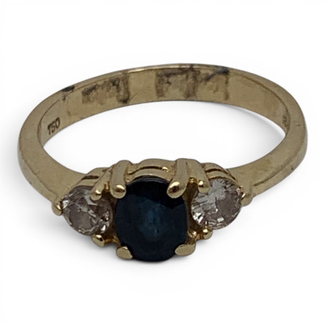 18k Yellow Gold Diamond & Sapphire Ring: 18k Yellow Gold Ring Featuring A Center Set Oval Cut Blue Sapphire Gemstone Flanked By 2 Round Cut White Diamonds Approx. 0.15ct EachMarked 18k - 5.25 - 2.0 DwtGemstones Tested With Presidium Gem
