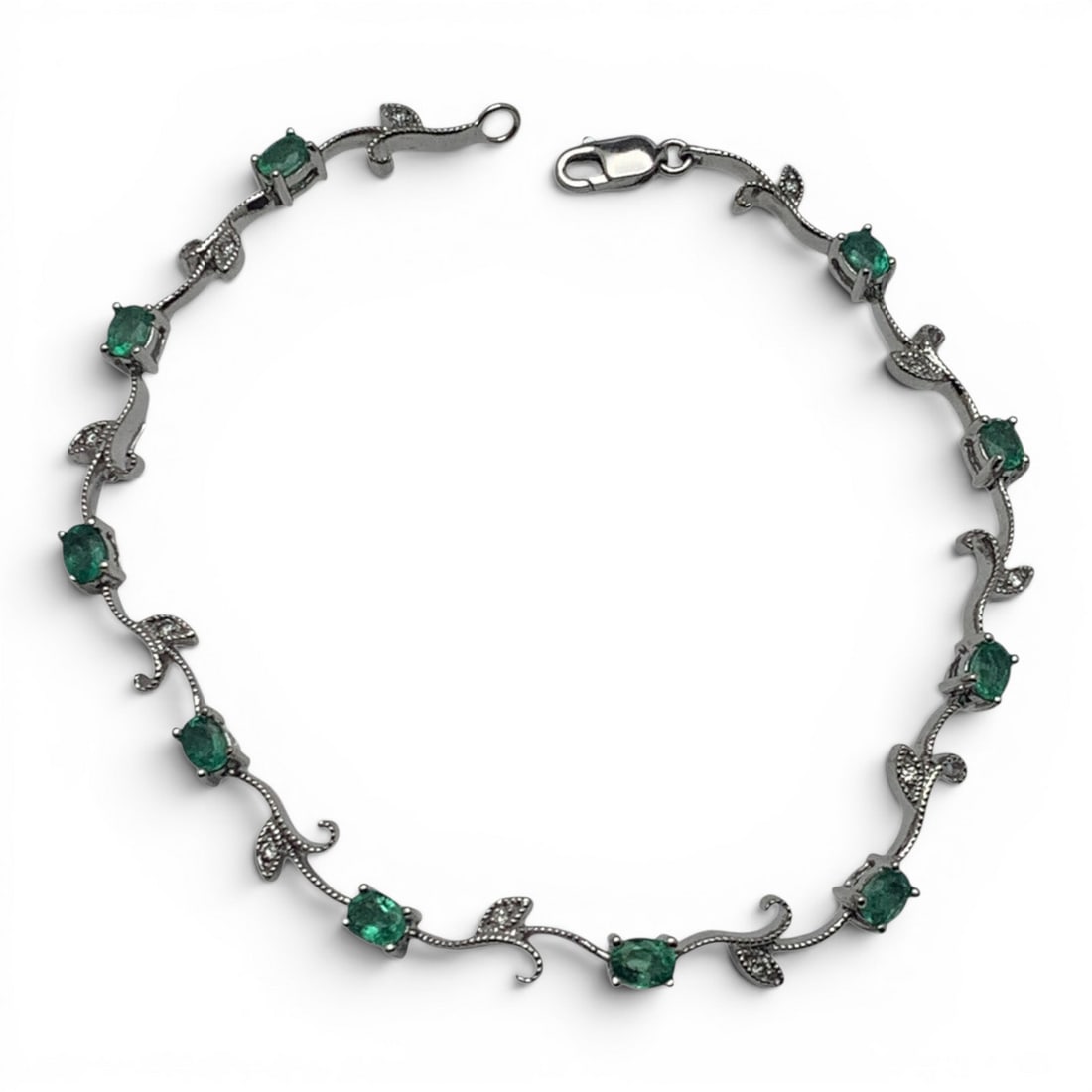 Vintage 14k White Gold Diamond & Emerald Bracelet: Vintage 14k White Gold Bracelet With A Vine & Leaf Design Featuring 10 Oval Cut Emerald Gemstones & 11 Round Cut Lab Grown Diamonds Approx. 0.01ct Each.Marked 585 - 7 1/2" Long - 4.2 DwtGemstones