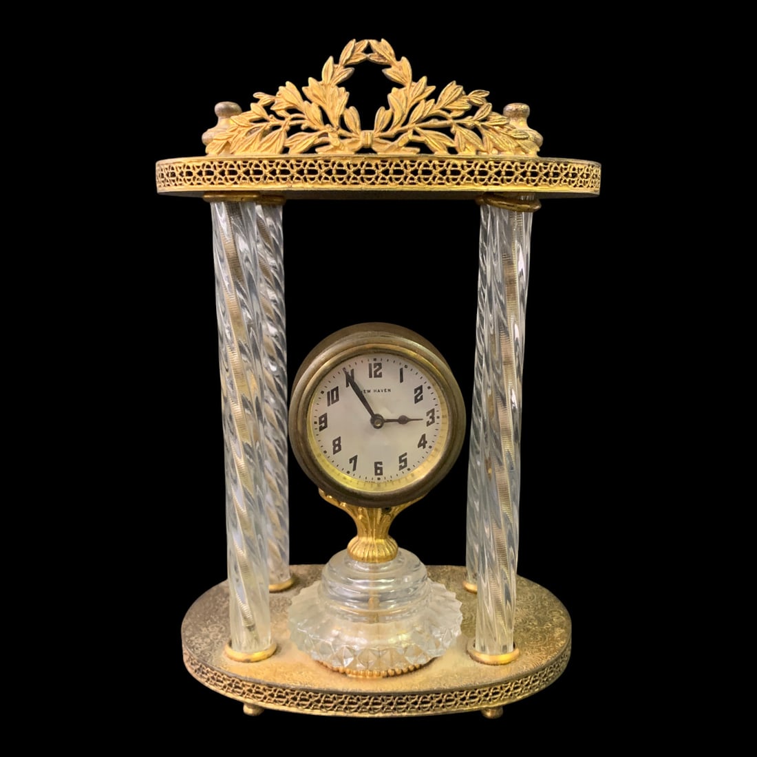 Antique Brass Desk Clock: Antique Brass Desk Clock Featuring Twisted Crystal Style Pillars And A Gold Tone Ornate Leaf Wreath TopMarked On Face: New Haven9 1/2" Tall