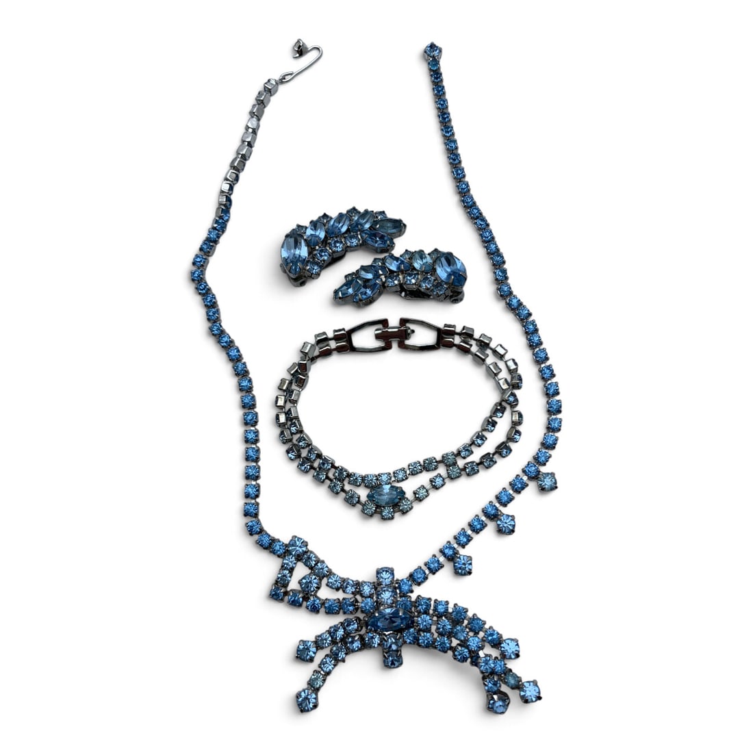 Vintage Silver Tone Fashion Jewelry: Vintage Silver Tone Fashion Jewelry Featuring Blue Rhinestones Including One Necklace, One Bracelet, And One Pair Of Clip Earrings Necklace: 15 3/4" Long Bracelet: 7 1/8" LongEarrings: 1 3/8" Long