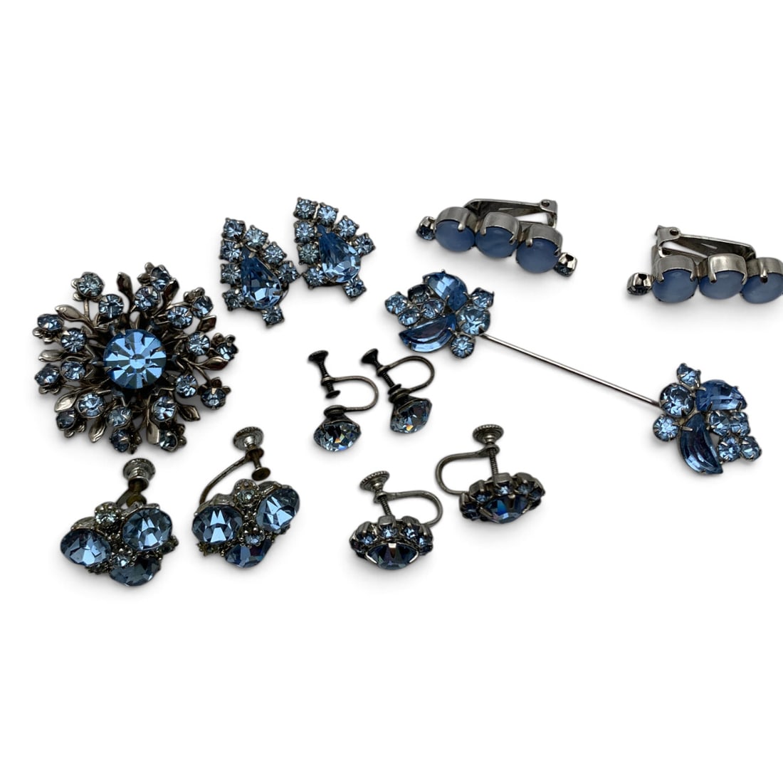 Grouping Of Vintage Blue Rhinestone Jewelry: Grouping Of Silver Tone Fashion Jewelry All Featuring Blue Rhinestones Including 5 Sets Of Earrings, 1 Sweater Pin, & 1 BroochEarrings: 1/2" - 1 1/4" LongSweater Pin: 3 1/8" LongBrooch: 1 1/2" Long