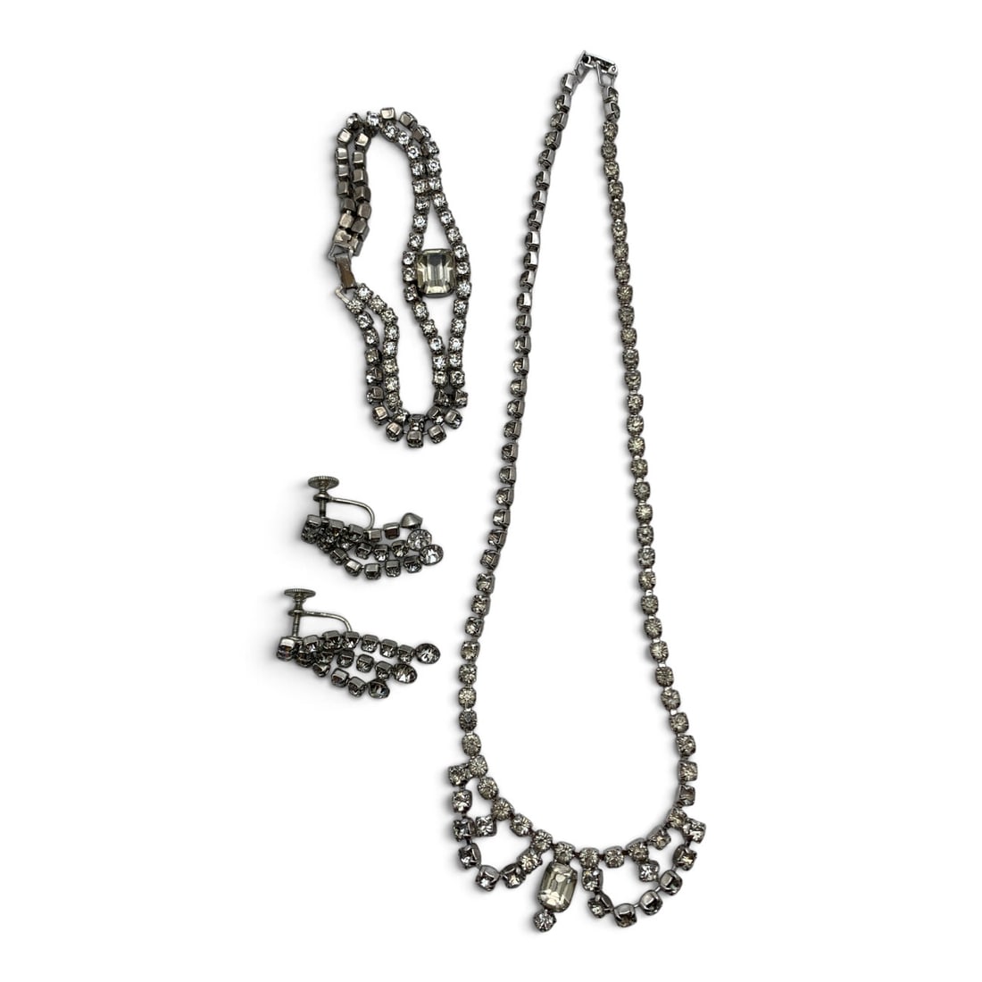 Vintage Silver Tone Rhinestone Jewelry Set: Vintage Silver Tone Jewelry Set Including One Bracelet, One Necklace, And One Pair Of Earrings Featuring Clear Rhinestones Bracelet: 6 7/8" Long Earrings: 1 1/4" LongNecklace 15" Long