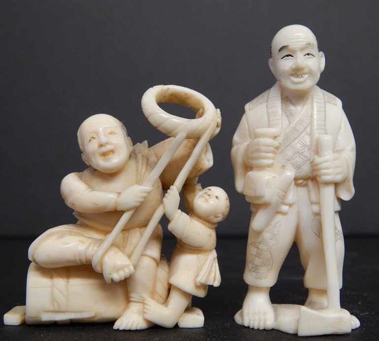 (2) ANTIQUE IVORY NETSUKE FIGURES: MAN W/ CHILD-5.5X4.5 CM MAN W/ AX-6X3 CM WE DO NOT SELL OR SHIP IVORY TO INTERNATIONAL BUYERS. MUST SHOW USA RESIDENCY.