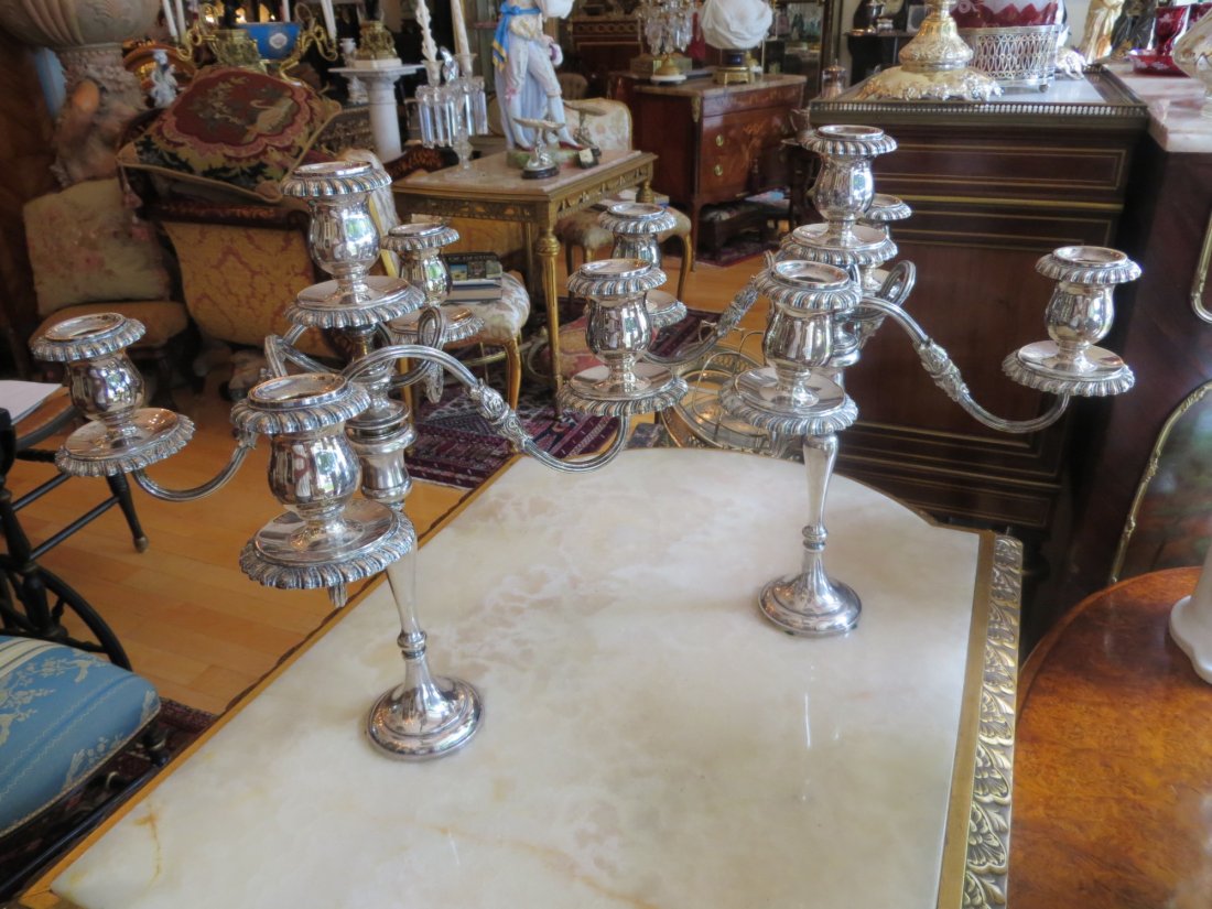 Pair of Silver-Plated Five-Light Candelabra: A pair of assembled silver-plated five-light candelabra, circa 1900 and later, each having four reed and leaf scroll branches and with gadroon bordered drip trays and nozzles to the baluster sconces, 