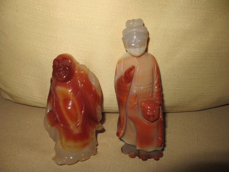 Two Chinese Carnelian Figures: Two Chinese Carnelian Figures; a 4 inch high figure of the Budhi and a 5 inch carving of Kuan-Yin with a child at her feet.