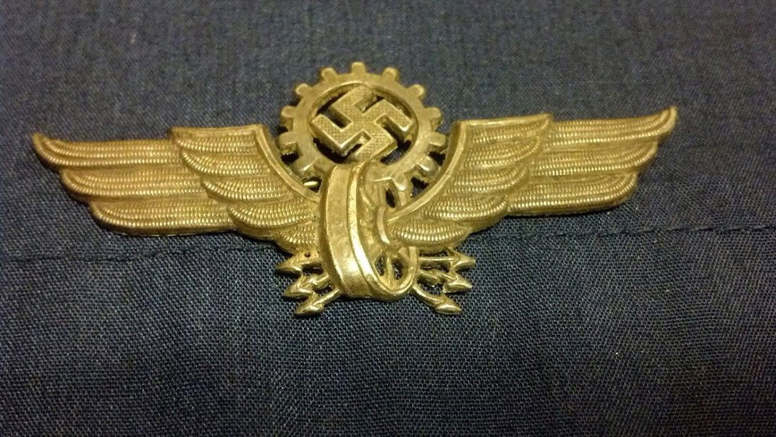 Nazi CogWheel RZM Marked Hat Insignia RARE: Very Unique and equally hard to find World War 2 German Transportation Cogwheel Hat Insignia. Marked RZM M1/53, original issued during WW2. 1 Brass fitting remains intact. Excellent patina