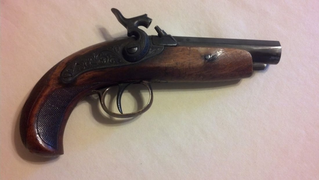 Spanish Made percussion cap dueling pistol 12mm: Very nice vintage dueling pistol with ornate lock plate design and stock engraving. Barrel Octagon with Made in Spain on top with 12mm. From a military veteran's estate collection. Trigger and hammer 