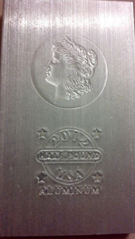 Two 1/2 pound Pure Aluminum Bars engineering gift!: Unique gift for any metal workers or engineers especially! Two 1/2 pound bars of pure aluminum bullion. Marked with design of the famous Morgan Silver Dollar as well as mint and weight.