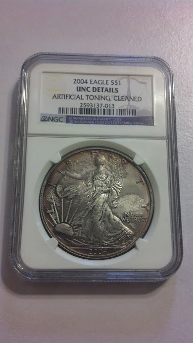 NGC Graded American Silver Eagle 1 Troy Oz Toning: Beautiful NGC Graded American Silver Eagle 1 Ounce pure .999 Silver. Checked and Verified vs NGC's coin database. Coin was exposed to various metals in safe, purple tone over a near flawless MS Grade