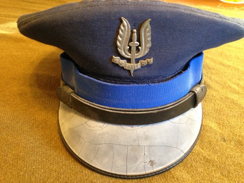 British SAS Officer Visor Cap Cold War post WW2: Rare British SAS special forces officer visor cap. Sword with wings insignia reading the SAS motto, "who dares wins" Worn by one of the most elite combat trained men in the world!