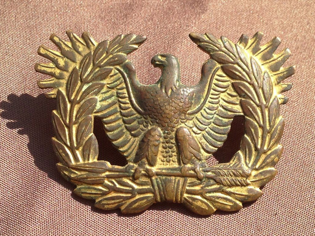 United States Warrant Officer Hat Insignia: Excellent original United States WW2 Era Warrant Officer Hat Insignia. We will include an extra screw back for fitting on hat by request. Excellent display piece great luster.