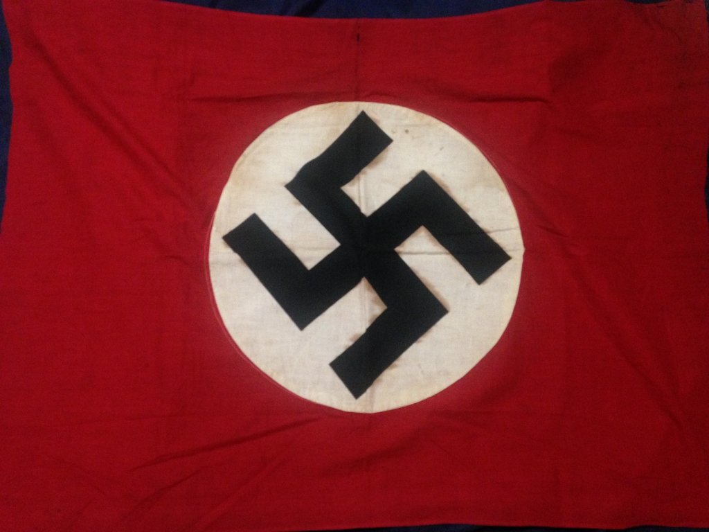 WW2 Vet Bringback Nazi Flag from Florida Estate: Beautiful Nazi Flag with circle sewn onto each side, no glow and a few spots of what appears to be blood. From a WW2 Veteran's Estate who was part of the invasion and occupation of Germany.