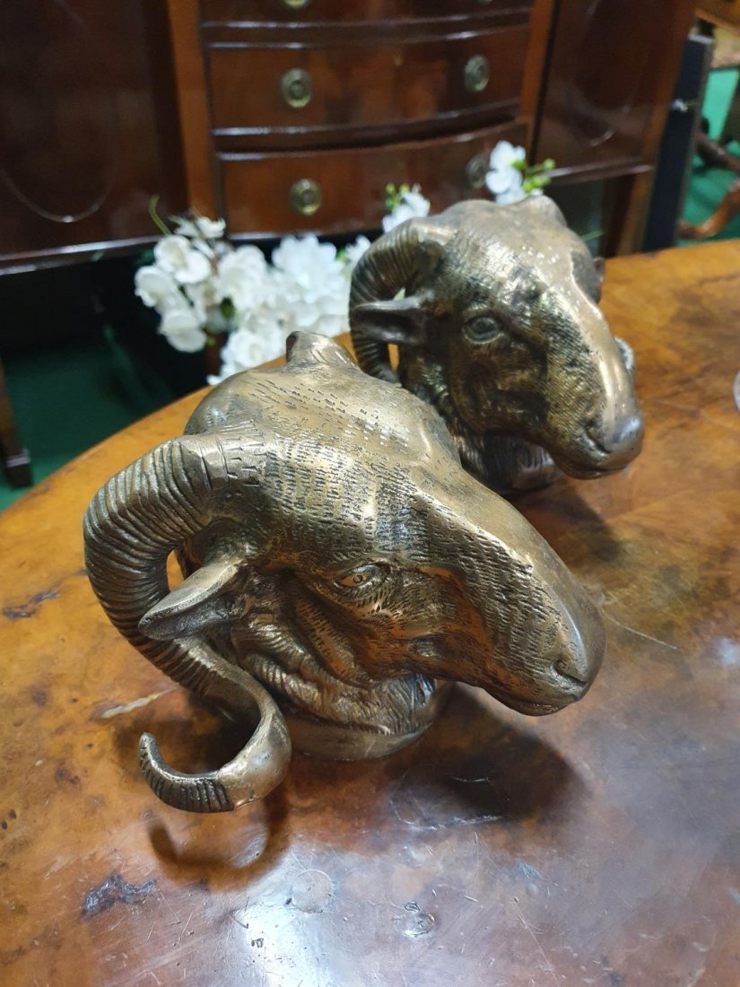 A pair of Brass wall mounted Rams Heads.: A pair of Brass wall mounted Rams Heads.