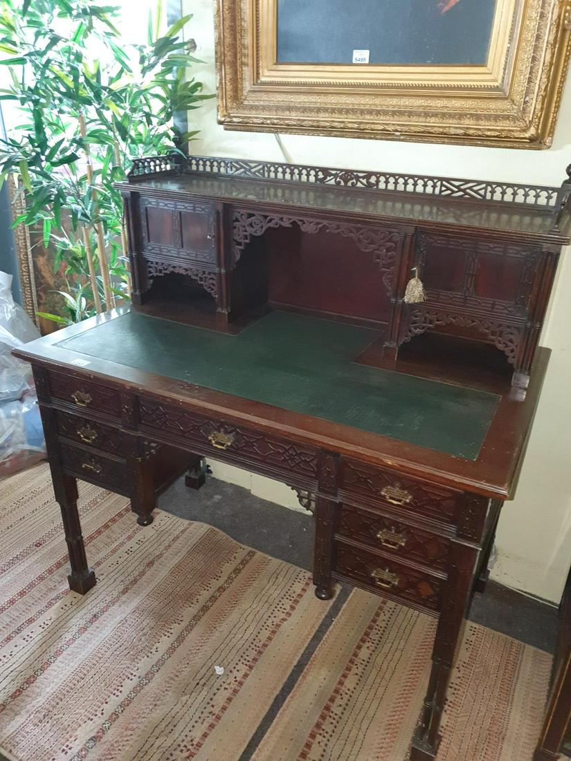 An Edwardian Mahogany Kneehole Writing Desk in the: An Edwardian Mahogany Kneehole Writing Desk in the Chippendale style with leather top and gallery back. W 109 x H 75 x D 66 cm approx. (1) (19).