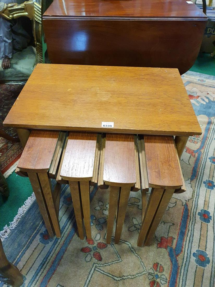 An unusual 20th Century Teak Nest of four Tables all: An unusual 20th Century Teak Nest of four Tables all pulling out from under a larger table. (5) (21).