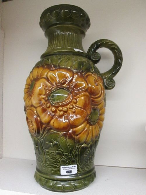 A Tall West German Pottery Vase with Handle, decorated : A Tall West German Pottery Vase with Handle, decorated in relief with sunflowers and with raised mark to base 487-45. 45cm high.