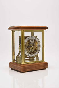 A German three train brass four glass mantel clock by Kieninger: A German three train brass four glass mantel clock by KieningerThe movement with Westminster chimes on an eight rod gong, the silvered chapter ring with black Roman hour numerals and subsidiary second