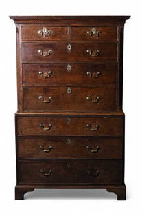 A George III oak chest on chest: A George III oak chest on chestThe upper section with cavetto and Greek key cornice, above two short and three long graduated and cock-beaded drawers, flanked by fluted canted corners, the lower secti
