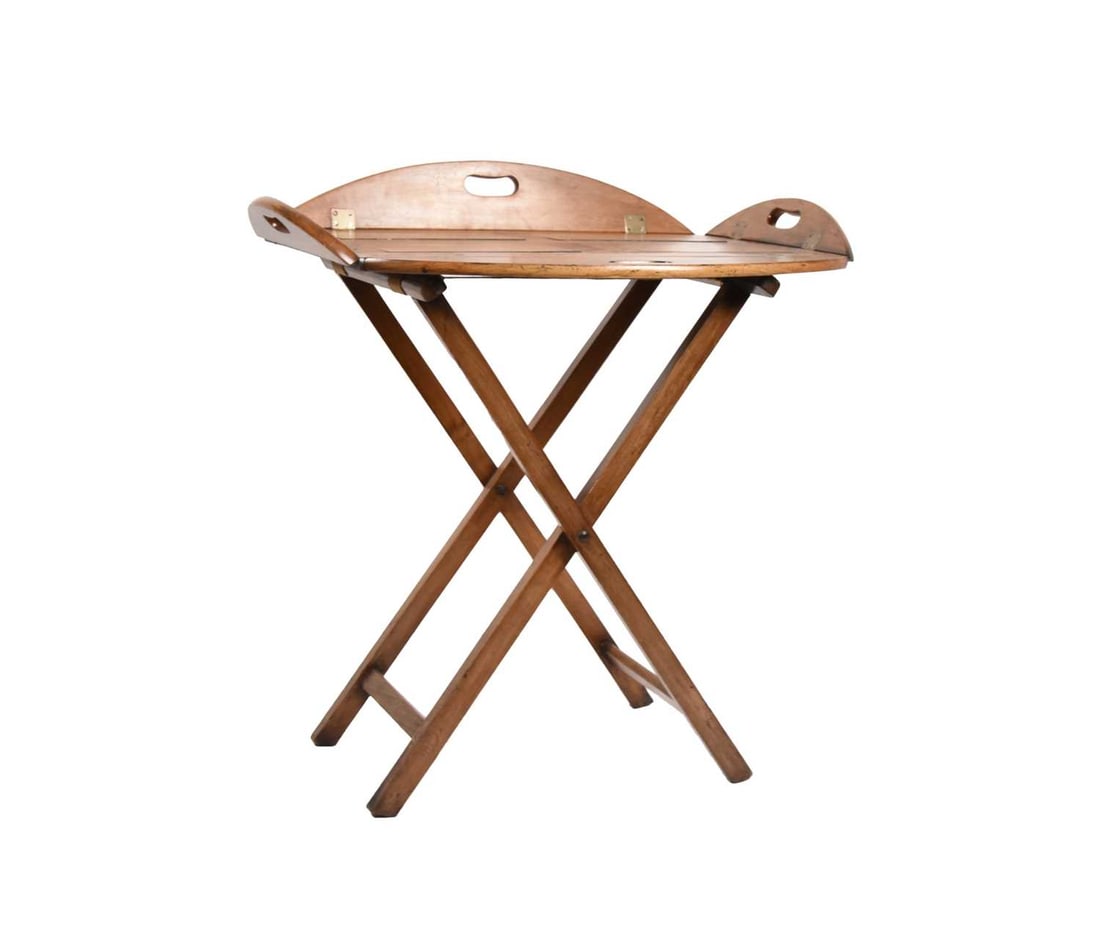 An early 19th century walnut butler's tray with folding stand: An early 19th century walnut butler's tray with folding standThe brass hinged top with carrying handles to all four sides, on a plain x-frame folding base.75cm wide x 50.5cm deep x 82cm high with side