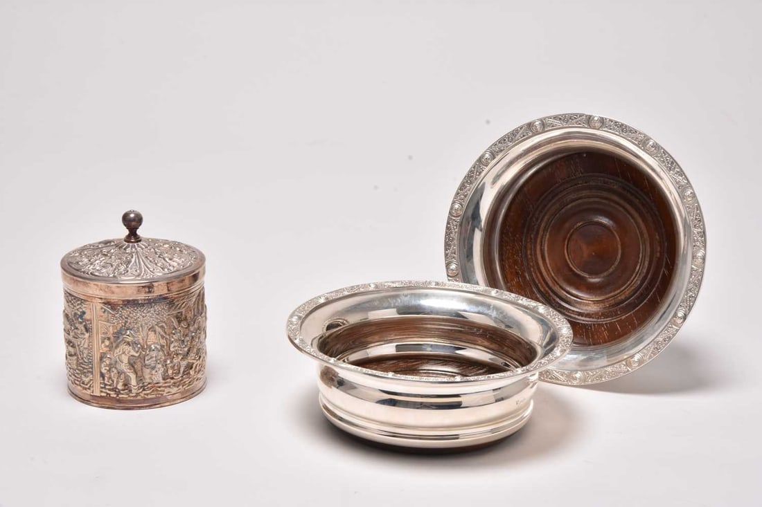 A pair of modern silver mounted wine coasters: A pair of modern silver mounted wine coasters, Birmingham 1975, 15.5cm diameter, together with a white metal tea cannister and cover, not stamped (3)