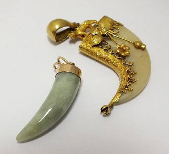 Halls Summer Collective Auction 21st August: A jadeite pendant, the yellow metal clasp stamped '14k', together with a yellow metal mounted tigers claw pendant (2)