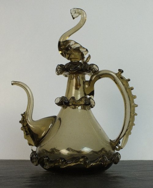 Halls Summer Collective Auction 21st August: A 17th century jug, possibly Venetian, brown glass with cresting over body and handle, the stopper modelled in the form of a bird, rough pontil mark, 19.5cm high