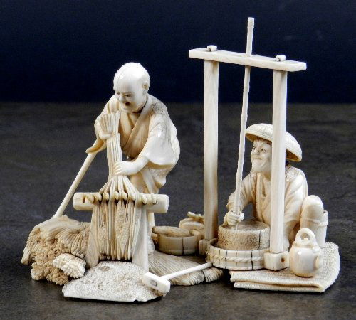 A Japanese ivory okimono group, Meiji: A Japanese ivory okimono group, Meiji period(1867-1912), signed on a red tablet, stencilled details, a young farmer threshing rice crops, and the elder man wearing a straw hat sitting down grinding th