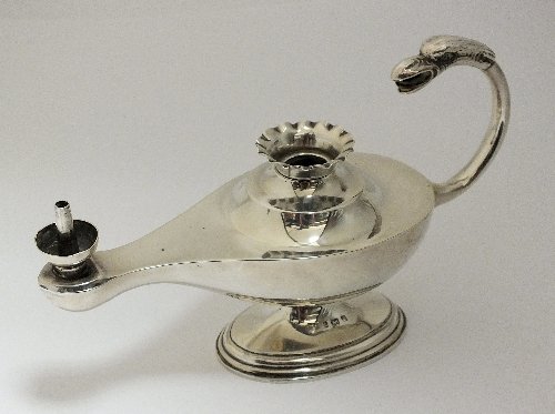 A Victorian silver oil lamp, makers marked rubbed,: A Victorian silver oil lamp, makers marked rubbed, Birmingham 1900, the Aladdin style lamp with bird cast handle and raised on oval pedestal base, 9.5cm high, weight 3.2oz