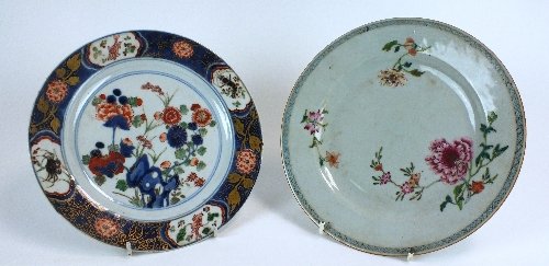 A Chinese famille rose export porcelain plate, 18th: A Chinese famille rose export porcelain plate, 18th century, painted with three flower sprays scattered around the well, within a formal border; and a European imari plate, 19th century, brightly deco