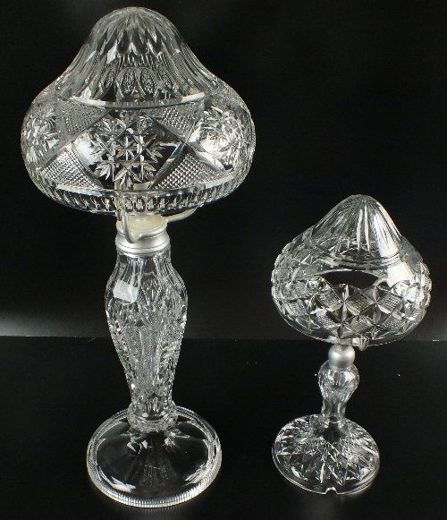 A Thomas Webb & Sons crystal glass lamp and shade,: A Thomas Webb & Sons crystal glass lamp and shade, together with one larger unmarked lamp and shade, mid 20th century, both with cut glass bodies and mushroom shades, the taller lamp's body also with