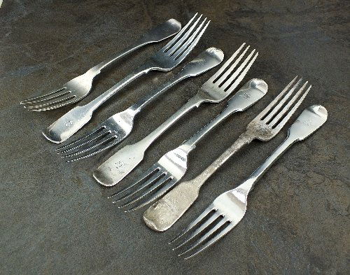 Seven Fiddle pattern silver table forks, comprising; a: Seven Fiddle pattern silver table forks, comprising; a pair by John Sutter, Chester 1844, a pair by John William Blake, London 1824, a pair by William Eaton, London 1830 and a further fork, all engrav