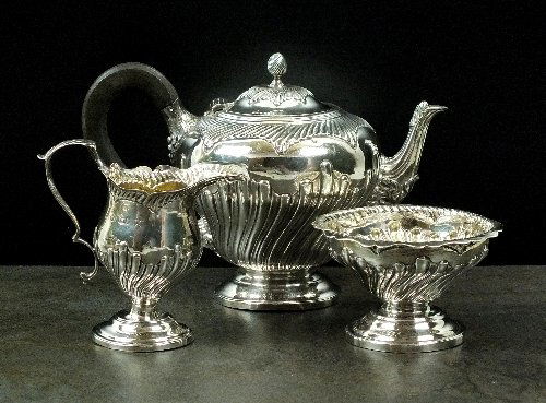 A Victorian bachelors three piece silver tea service,: A Victorian bachelors three piece silver tea service, Charles Stuart Harris, London 1890, each piece of inverted pear shaped form with wrythen embossed decoration, comprising; a teapot with bud finial